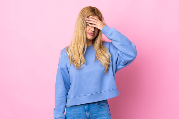 Young Uruguayan blonde woman over isolated pink background with tired and sick expression - Photo, Image