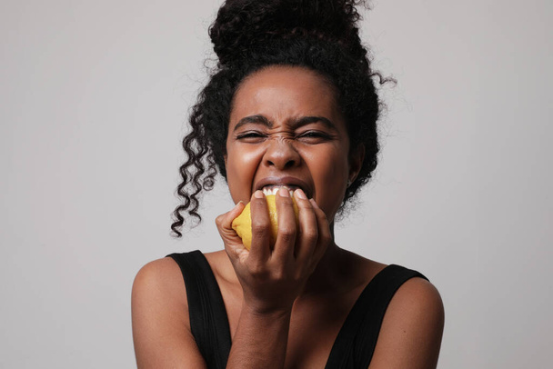 Cropped photo of woman posing with lemon on white wall for skin and body care - Photo, image