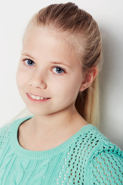 Giving you a smile. Portrait of a confident young girl standing in the studio. - Foto, immagini