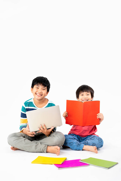 Ritratto di Happy asian boys, Fratello al piano con laptop e libri isolati su sfondo bianco, Educazione e apprendimento con concetto tecnologico - Foto, immagini