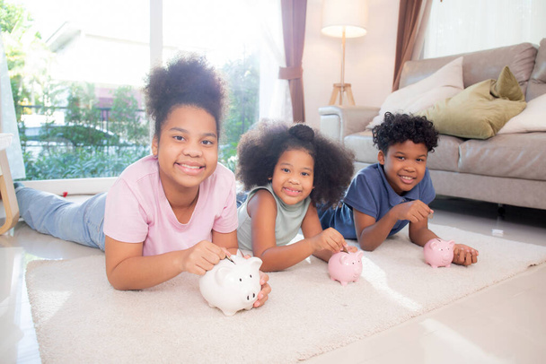 Щастя африканської сім'ї з дітьми, які заощаджують гроші в голубиному банку для планування майбутнього витрат на фінансовий успіх, депозит і інвестиції, сімейне життя, бізнес і фінансова концепція. - Фото, зображення
