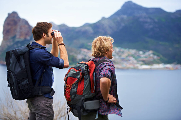 The view is unbelievable. Two male backpackers admiring a great view. - Photo, Image