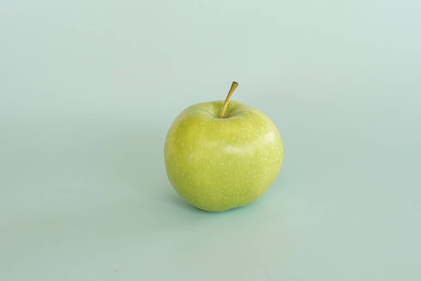 close up of green apple against blue background - Fotó, kép