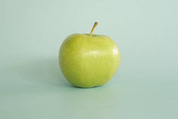 крупним планом зелене яблуко на синьому фоні
 - Фото, зображення