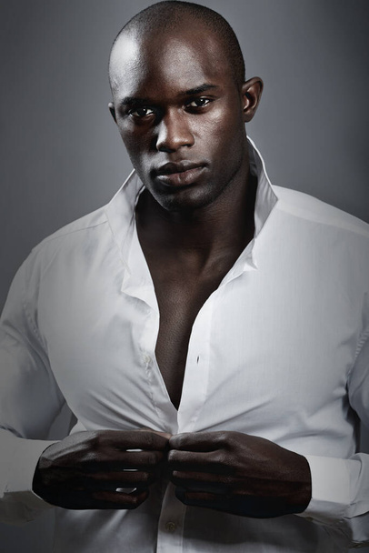 Masculine confidence. A handsome african man modeling clothes in studio. - Foto, Imagen