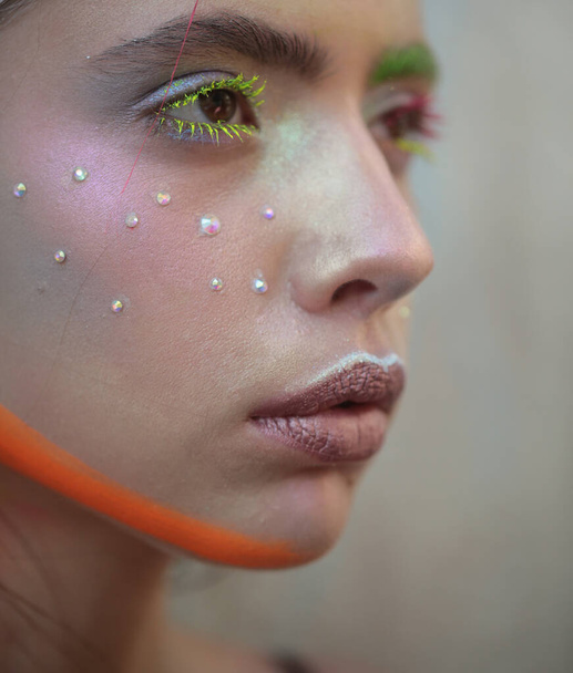 Art design. Fashion model girl with colorful powder make up. Beauty woman with bright color makeup. Closeup of vogue style face. Abstract colourful make-up. - Fotó, kép