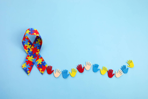 Autism awareness concept with colorful hands on blue background. Top view - Valokuva, kuva