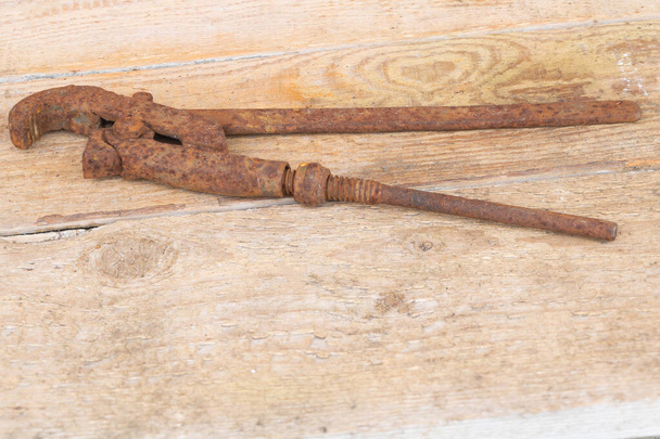 An old rusty iron adjustable spanner on wooden background - Valokuva, kuva