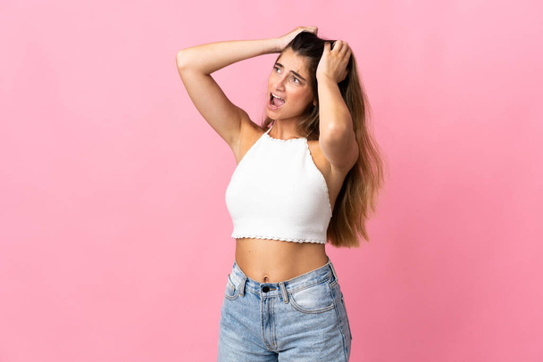 Young caucasian woman isolated on pink background stressed overwhelmed - Photo, image