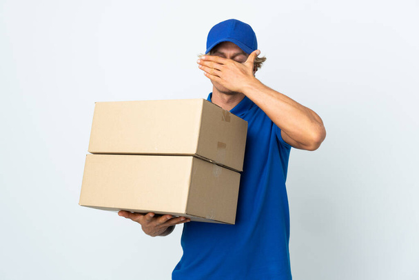 Delivery man over isolated white background covering eyes by hands. Do not want to see something - Foto, immagini