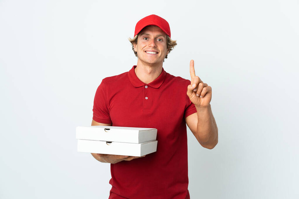 pizza delivery man over isolated white background pointing up a great idea - Foto, Bild