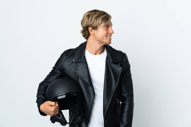 English man holding a motorcycle helmet looking side - Photo, image