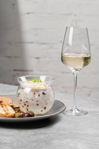 Pike caviar in a glass vase on ice with green onions and croutons. Fish caviar, a delicacy. A gourmet dish. Apetizer. Delicious food, frills for special connoisseurs. - Photo, Image