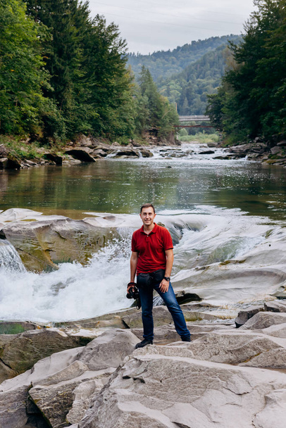 Man tourist visit river Prut and waterfall Probiy in Yaremche, Carpathians, Ukraine - Photo, Image