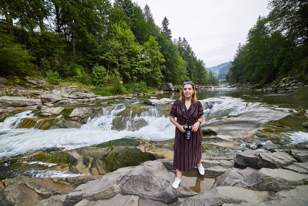 Woman tourist visit river Prut and waterfall Probiy in Yaremche, Carpathians, Ukraine - Photo, Image