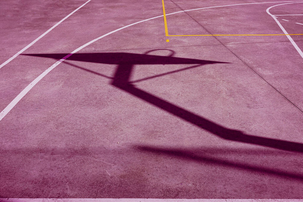             street basket silhouette on the pink court                     - Photo, Image