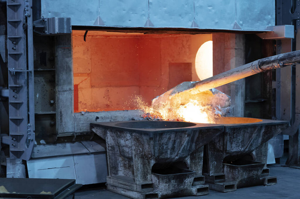 skimming melted aluminum for removing the dross before casting. Aluminum foundry works showing an open furnace - Photo, Image