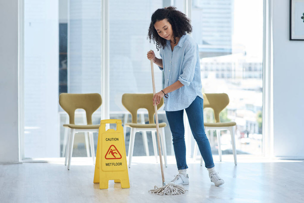 I have to be careful not to slip. Shot of a young woman mopping her floor at home. - Fotografie, Obrázek