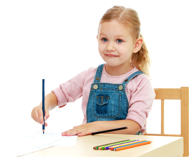 Little girl draws pencils sitting at the table. - Photo, Image