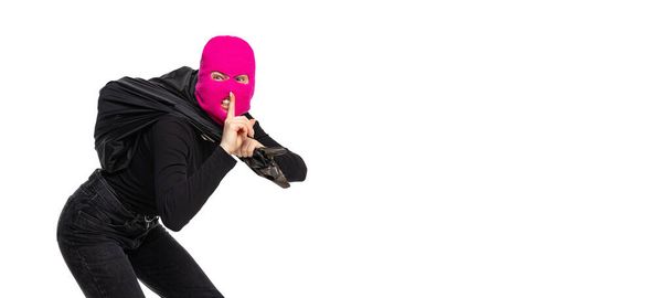 Portrait of young anonymous person wearing black outfit and balaclava isolated on white background. Concept of art, fashion, anti-terrorizm - Zdjęcie, obraz