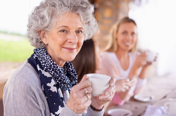 Tea revives you. Shot of three generations of the woman of the women of a family having tea outside. - Photo, image