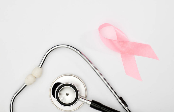 pink cancer ribbon with, stethoscope, white background ,international symbol of breast cancer awareness and moral support for women. Isolated background, - Φωτογραφία, εικόνα