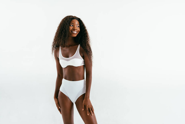Beauty portrait of beautiful black woman wearing lingerie underwear - Pretty african young woman posing in studio, concepts about beauty, cosmetology and diversity - Foto, afbeelding