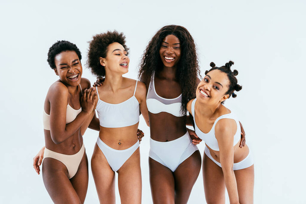 Beauty portrait of beautiful black women wearing lingerie underwear - Pretty african young women posing in studio, concepts about beauty, cosmetology and diversity - 写真・画像