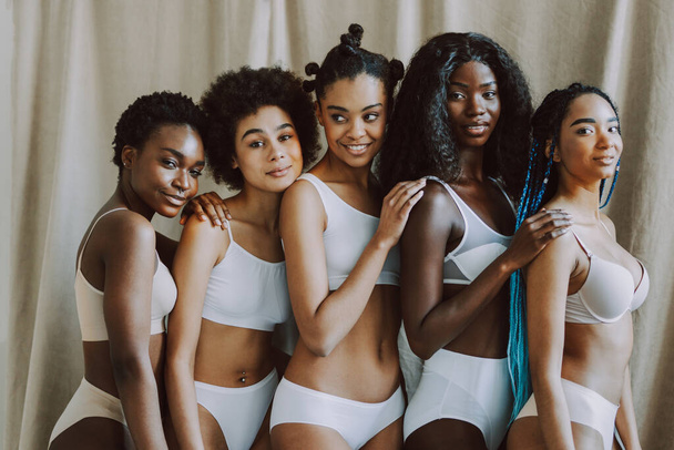 Beauty portrait of beautiful black women wearing lingerie underwear - Pretty african young women posing in studio, concepts about beauty, cosmetology and diversity - Foto, imagen