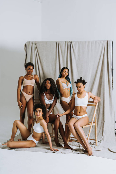 Beauty portrait of beautiful black women wearing lingerie underwear - Pretty african young women posing in studio, concepts about beauty, cosmetology and diversity - Photo, Image