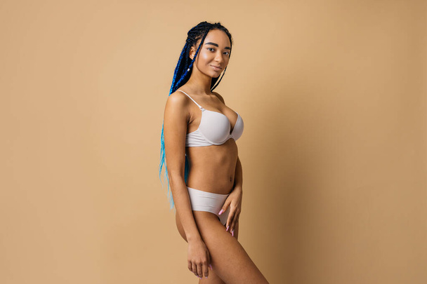 Beauty portrait of beautiful black woman wearing lingerie underwear - Pretty african young woman posing in studio, concepts about beauty, cosmetology and diversity - Foto, imagen