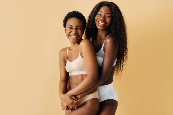 Beauty portrait of beautiful black women wearing lingerie underwear - Pretty african young women posing in studio, concepts about beauty, cosmetology and diversity - Photo, image