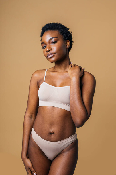 Beauty portrait of beautiful black woman wearing lingerie underwear - Pretty african young woman posing in studio, concepts about beauty, cosmetology and diversity - Photo, image