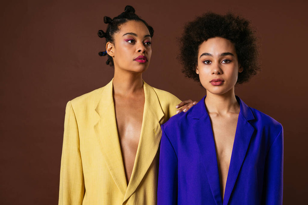 Beauty portrait of beautiful black women wearing lingerie underwear and colored blazers - Pretty african young women posing in studio, concepts about beauty, cosmetology and diversity - Foto, imagen