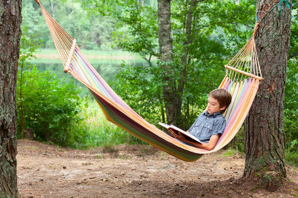 Child reading book in hammock  - Photo, Image