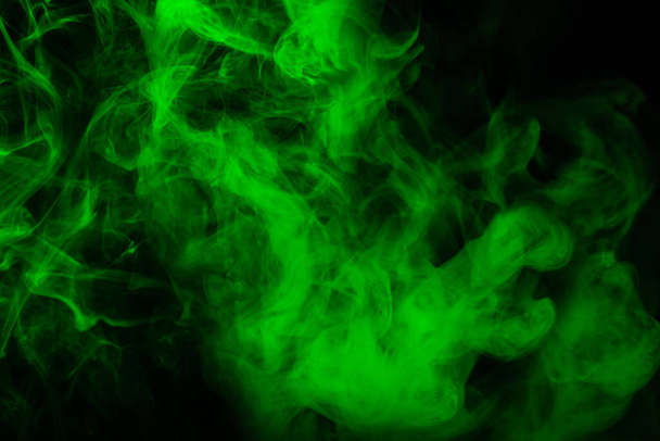 Green steam on a black background. Copy space. - Foto, imagen