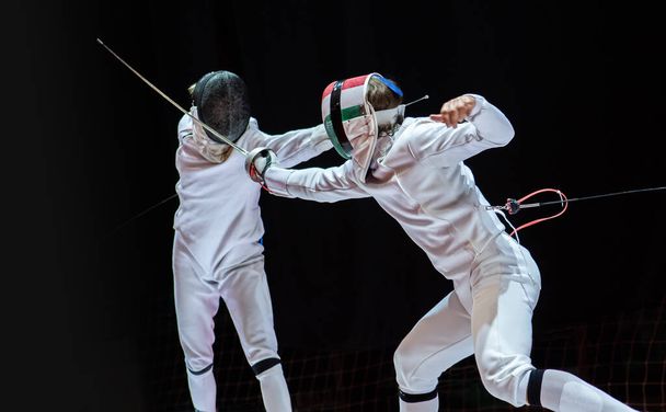 Fencer woman with fencing sword. Fencers duel concept - Photo, Image