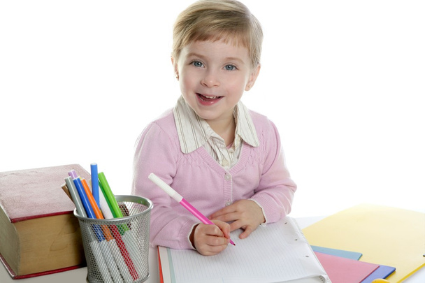 Little girl happy student on desk writing - 写真・画像