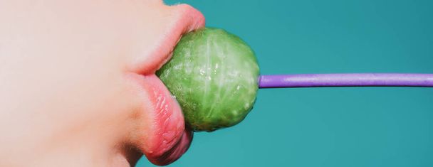 Close up lips with lollipop isolated, sexy blowjob, sensual mouth with lipstick eats sweets. Sexy design banner for women and girls. Beautiful lips. - Foto, afbeelding