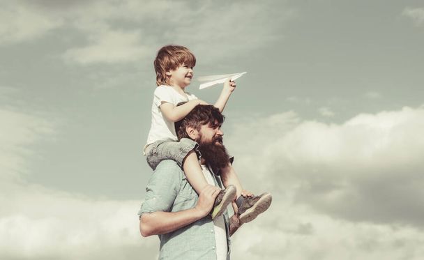 Fathers day. Dream of flying. Funny time. Enjoy. Happy family father and child on meadow with a kite in the summer on the nature. - Foto, imagen