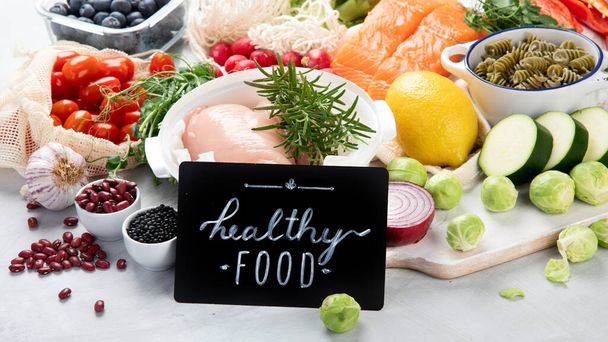 Healthy food assortment on light background. Clean eating concept.  - Fotó, kép