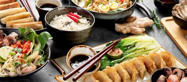 Asian food on dark background, top view. - Фото, изображение