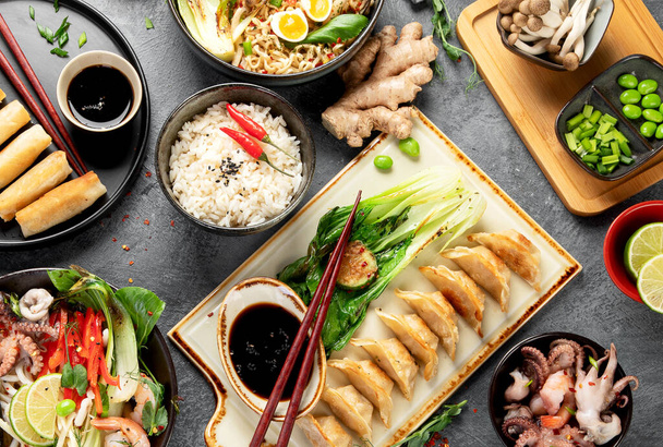 Asian food on dark background, top view. - Фото, изображение
