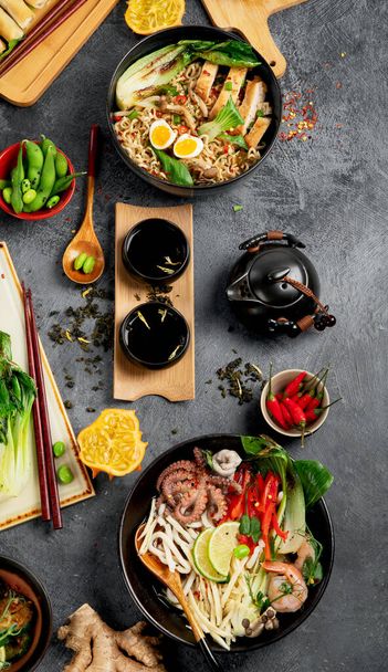 Asian food with various ingredients on dark background. Top view. - Fotó, kép