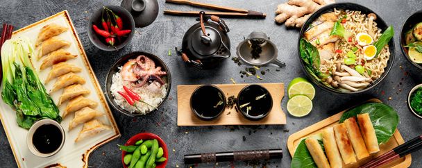 Asian food with various ingredients on dark background. Top view. - Фото, изображение