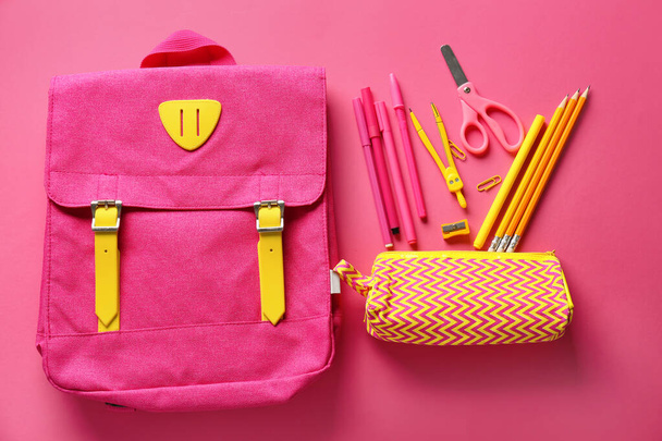 Pencil case with stationery and backpack on pink background - Zdjęcie, obraz