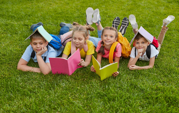 Preteen students with books in park - Foto, afbeelding