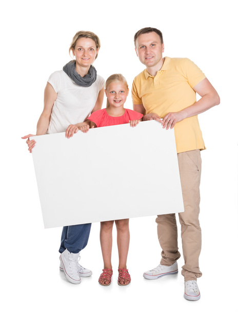 Happy Young Family Holding Banner - Foto, immagini