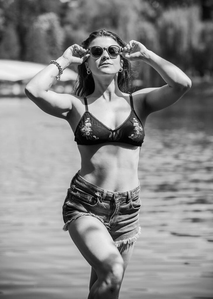 Beautiful nice girl wear bra, shorts at the water, summer fashionable concept - Fotografie, Obrázek