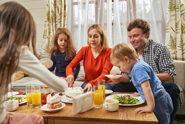 Portrait of family eating festive dinner at home - Foto, afbeelding